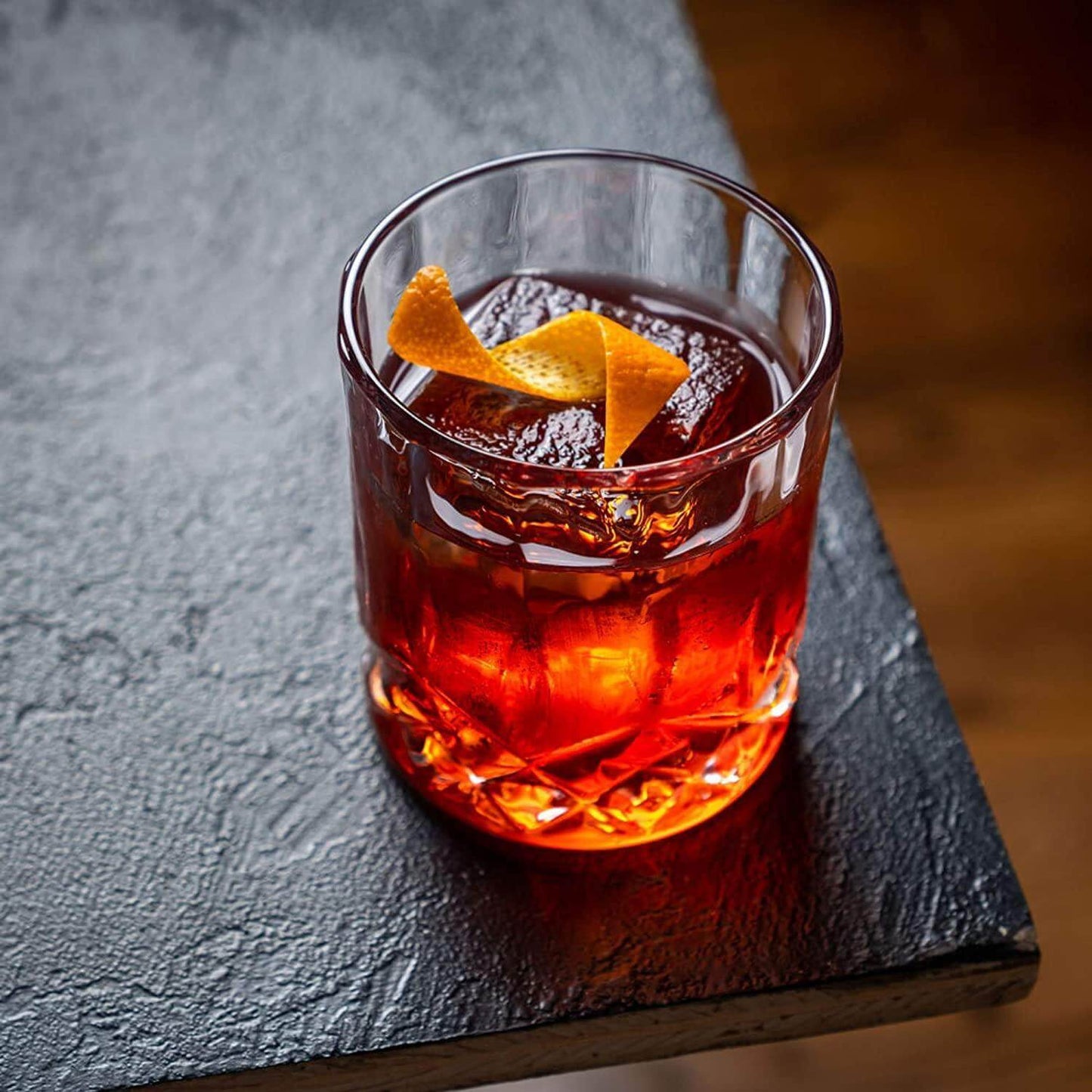 Whiskey connoisseur glass gift set signature edition — premium Father's Day gift for dad Red cocktail with an orange twist in a clear glass on a dark surface
