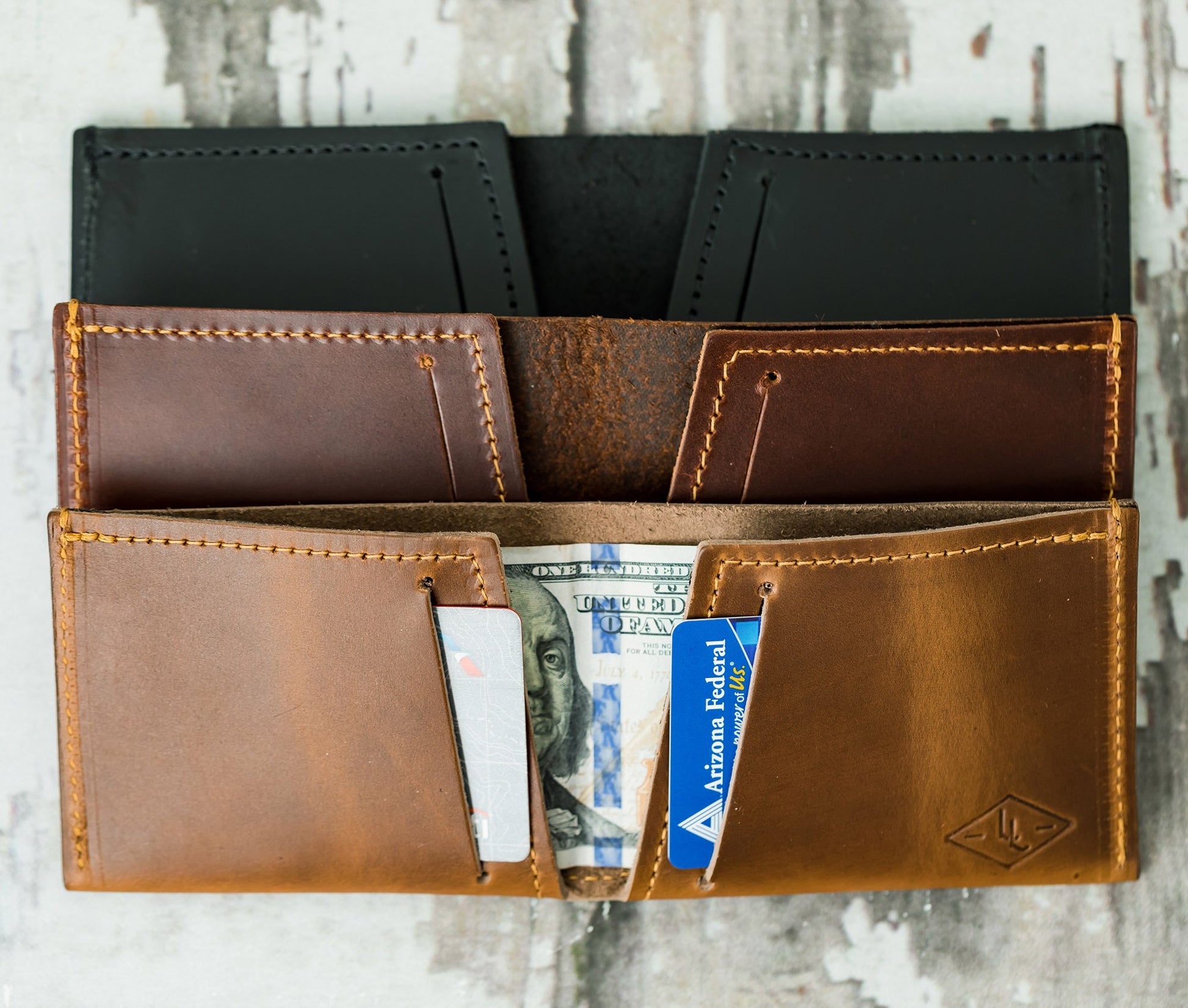 Brown leather wallet with money and cards on a wooden surface personalized gift for dad
