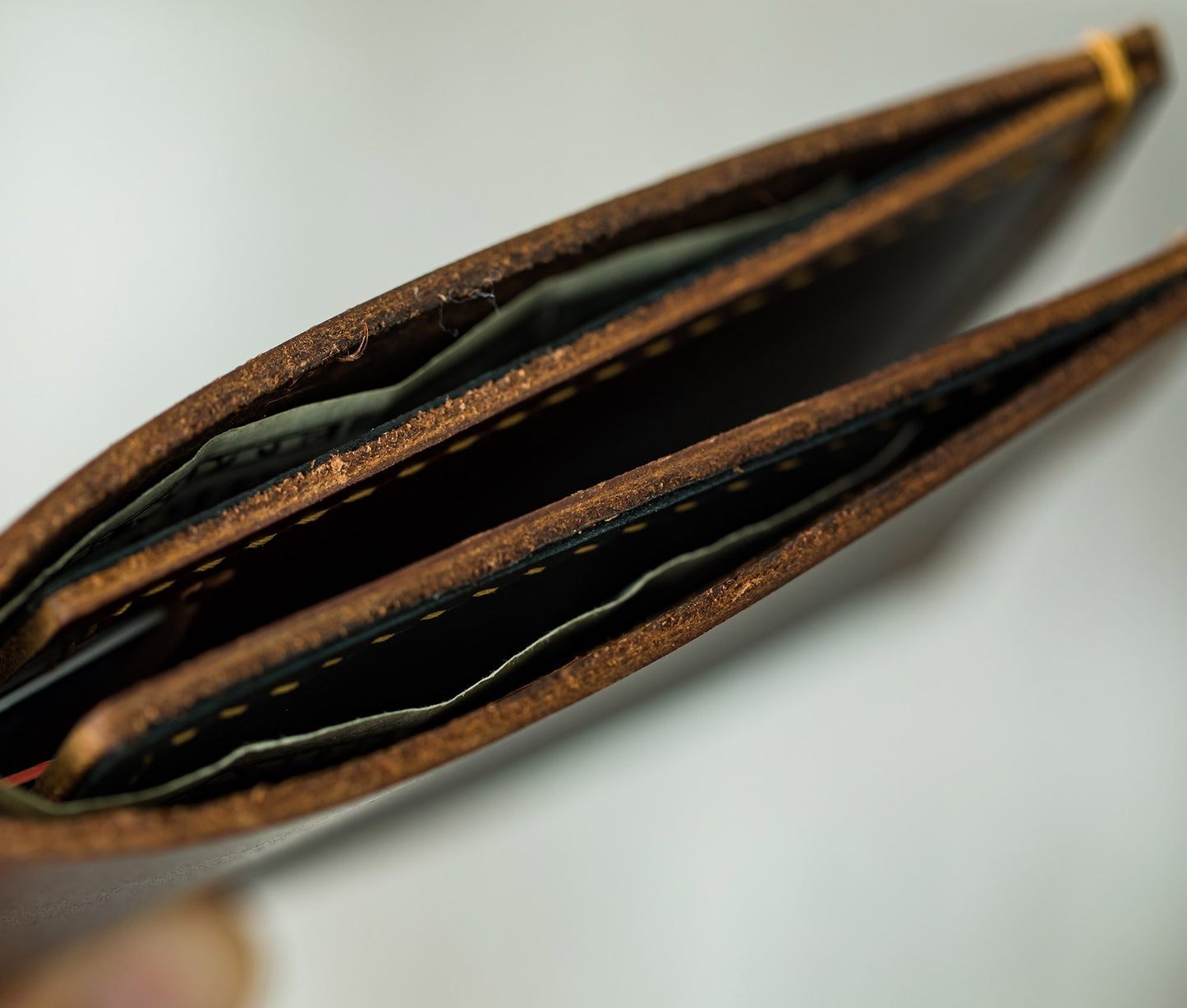 Close-up of a brown leather wallet with cards on a light gray background personalized gift for dad